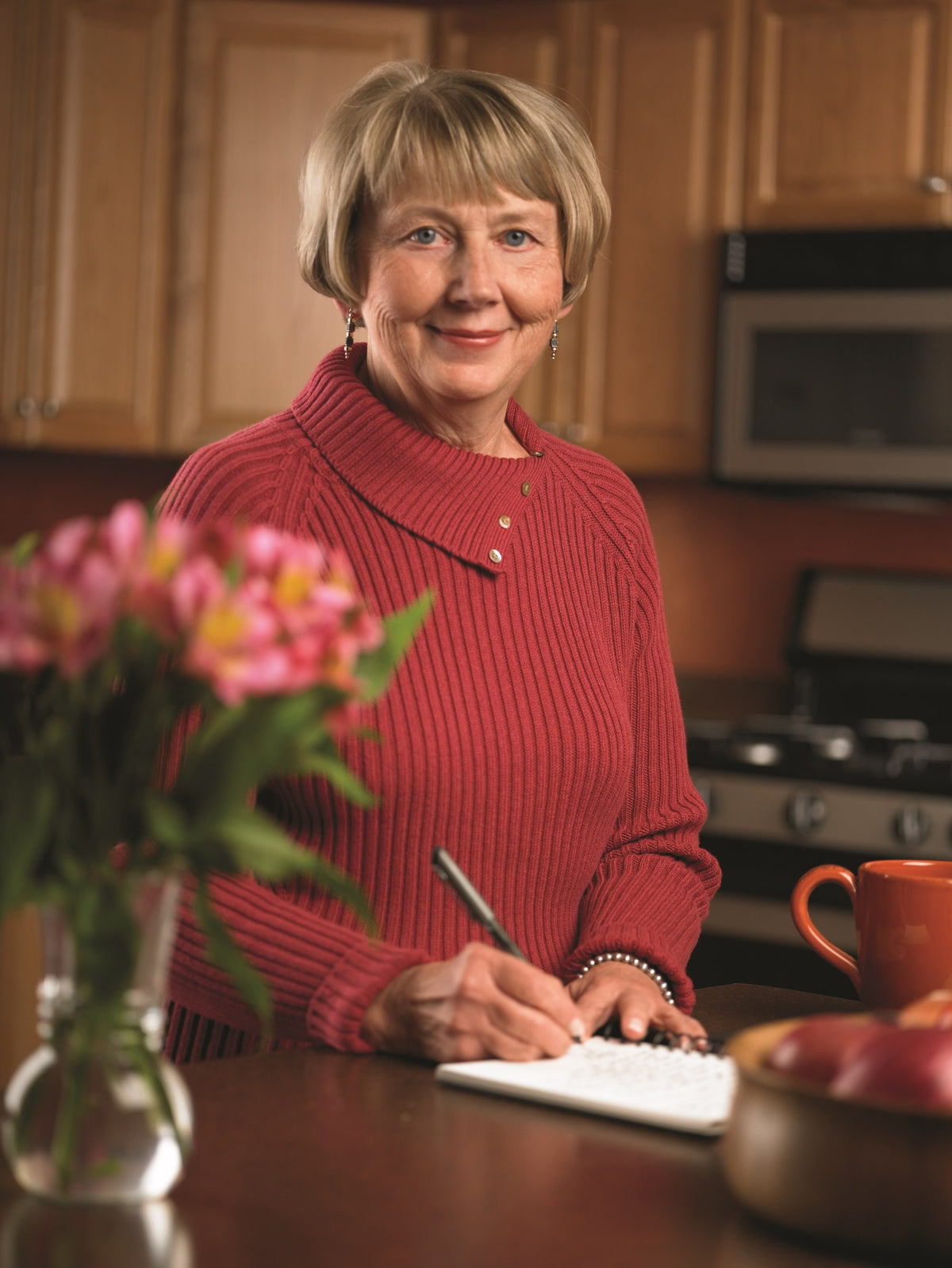 Jeri Mesching at her kitchen counter, writing